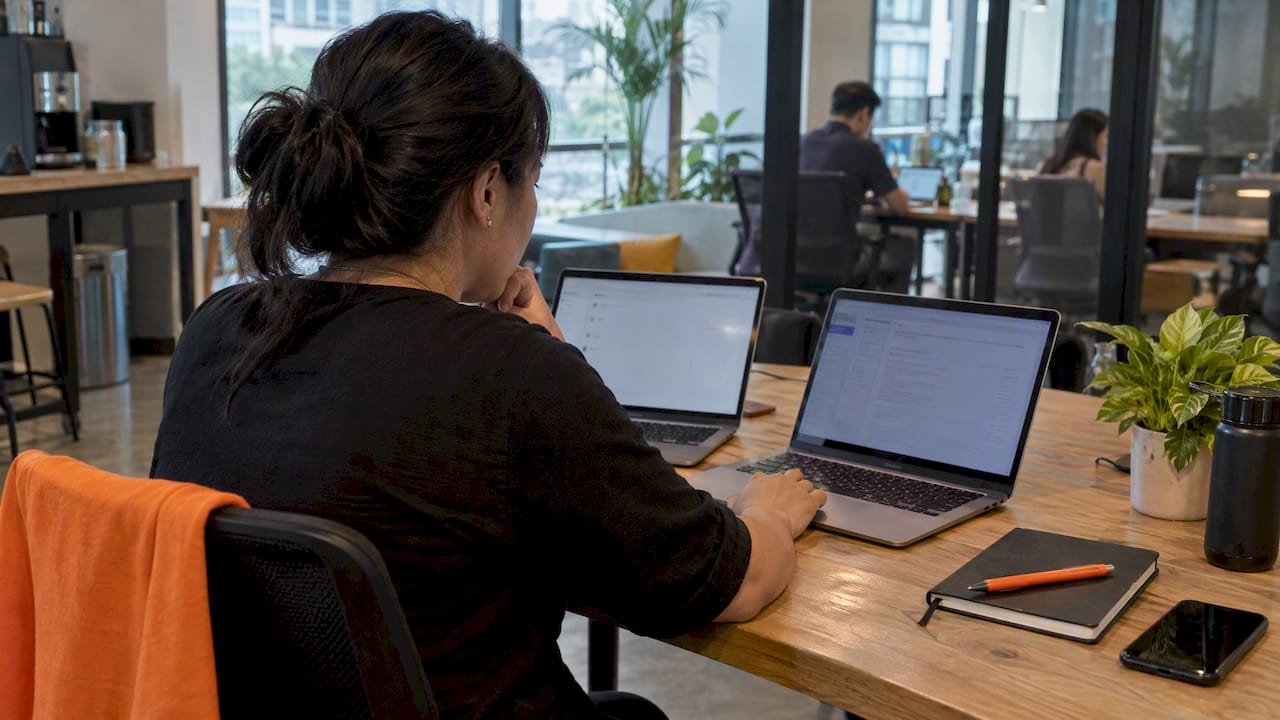 Manager comparing Notion and Confluence workspaces